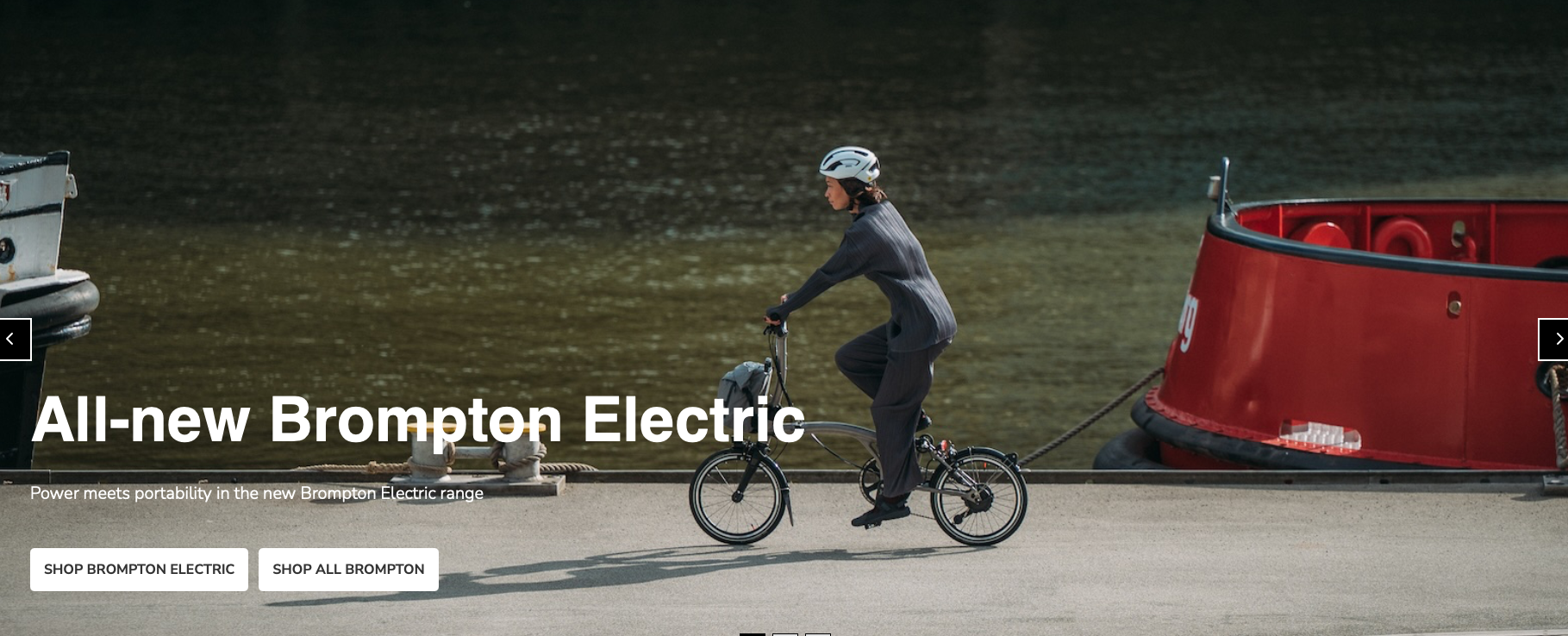 Ad for a leccy Brompton with what appears to be a large boat affixed to the rear of the bike being pedalled.