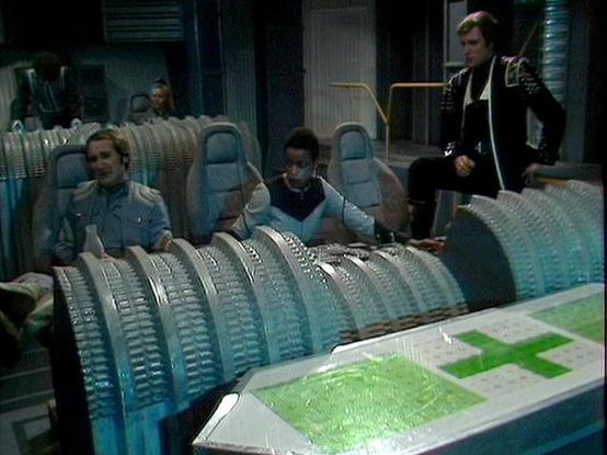 Claude Sonnet 4.0 describes the image as: "This appears to be a scene set in a futuristic medical facility or ship's medical bay. The setting features sleek, sterile-looking medical pods or treatment beds with transparent covers and metallic frameworks. The lighting has a cool, clinical blue-green tint typical of sci-fi medical environments. Several characters are present in the scene - some appear to be patients lying in the medical pods while others are standing nearby, likely medical personn…