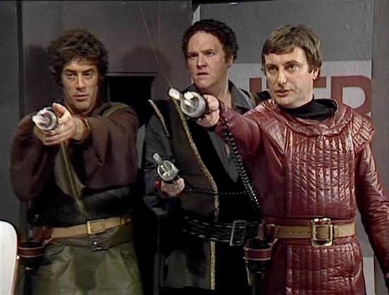 Claude Sonnet 4.0 describes the image as: "I can see three men in what appears to be a futuristic or science fiction setting, likely aboard a spacecraft. They're wearing distinctive costumes - one in brown/green clothing, another in dark attire with equipment straps, and the third in a burgundy leather outfit with decorative stitching. All three are holding what appear to be futuristic weapons or blasters pointed forward, suggesting they're in a tense combat or confrontational situation. The se…