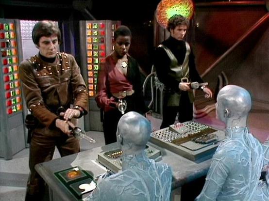 Claude Sonnet 4.0 describes the image as: "This scene appears to be set on a spaceship bridge or control room, featuring the characteristic futuristic set design with metallic surfaces and control panels. Three crew members are present - one wearing a distinctive studded leather outfit, another in burgundy/red clothing, and a third in dark attire. They appear to be confronting or negotiating with two translucent, crystalline humanoid beings who are seated at what looks like a control station. T…