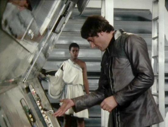 Claude Sonnet 4.0 describes the image as: "I can see this is a scene set in what appears to be a spacecraft interior, with metallic walls and a staircase visible in the background. The setting has the characteristic futuristic, industrial design typical of science fiction productions from this era. One person is wearing a flowing white dress or gown, while another is dressed in dark leather clothing and is operating some kind of control panel or technical equipment. The scene appears to be taki…