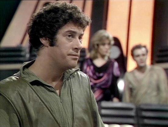 Claude Sonnet 4.0 describes the image as: "This appears to be a scene from the British science fiction television series "Blake's 7" from the late 1970s. The image shows what looks like the interior of a spacecraft or futuristic setting, with the characteristic design elements typical of the show's production. The scene appears to involve multiple characters in what seems to be a dramatic moment, with the lighting and composition suggesting this is from a key plot point in an episode. The produ…