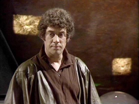 Claude Sonnet 4 describes the image as: "This image shows a scene from what appears to be a science fiction television production, likely from the late 1970s or early 1980s based on the visual style and production quality. The setting appears to be the interior of a spacecraft or futuristic facility, with characteristic lighting and metallic surfaces visible in the background.
The scene features dramatic lighting with warm, golden highlights against darker areas, creating an atmospheric mood t…