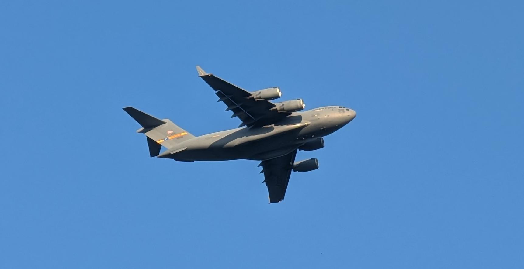 Background: Clear blue sky...
Middleground: Clear blue sky...
Foreground: My best identification is a Boeing C-17 Globemaster (?) aircraft flying above Me that I managed to quickly photo with my Google Pixel 10 Pro XL as it flew over Me... 

Created: 7/4/26 7:13pm
Aperture: ƒ∕2.8
Exposure: 1∕515 s
ISO: 54
Focal Length: 17.906 mm
Google Pixel 10 Pro XL