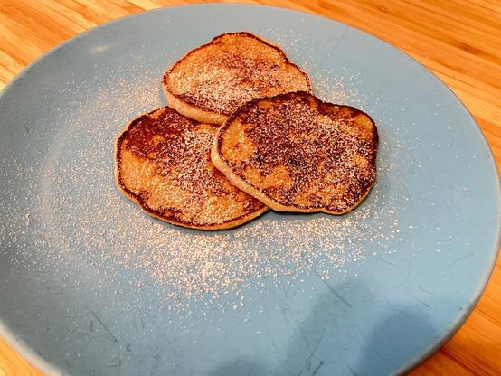 Pancakes dusted with cinnamon and powdered sugar