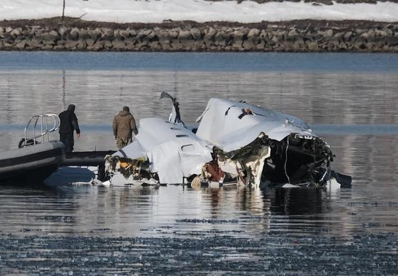 photo - removing aeroplane debris from the 2025 Potomac River air tragedy site