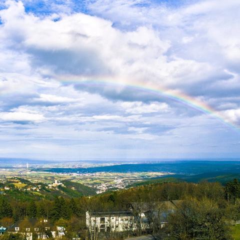 View of forchtenstein and mattersburg from the viewpoint rosalienkapelle with a rainbow, austria