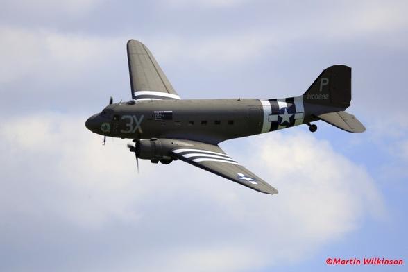 Douglas C47 Dakota flies through a cloudy sky at the annual East Kirkby Air display