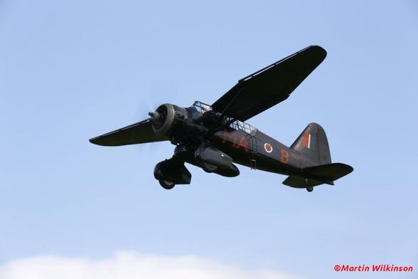 Westland Lysander flies through a blue sky at Old Warden during a Shuttleworth display.