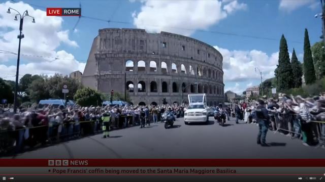 The Pope's funeral procession passing the Coliseum.