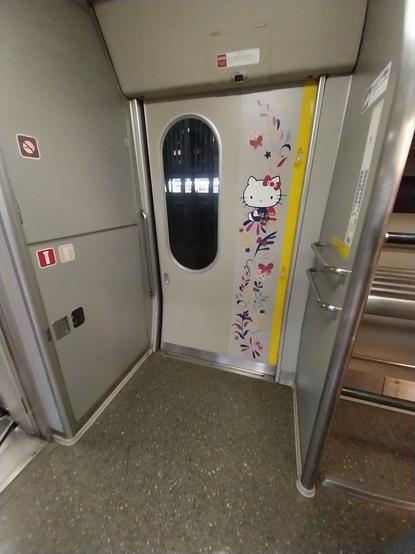 One of the doors within the Hello Kitty Shinkansen with floral artwork alongside Hello Kitty on it