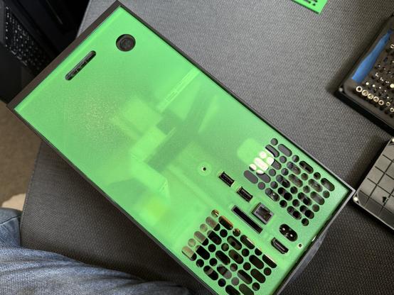 An Xbox Series X with a 3D printed back plate. It’s translucent as it’s so thin. This is just a fit test, hence the thickness.