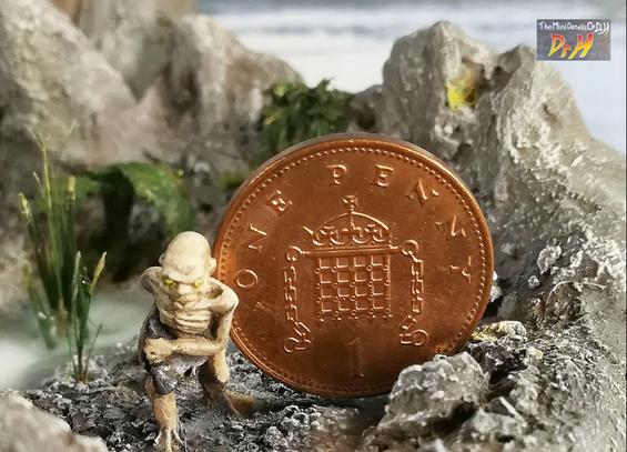 Scale photo of Gollum with a penny.