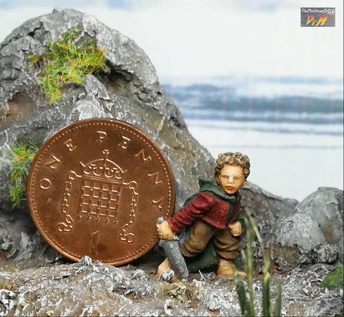 Scale view of Bilbo miniature with a one penny coin.