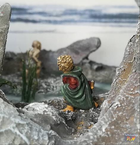 Rear view of Bilbo miniature with Gollum in the distance.