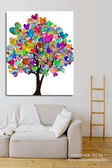 Colorful tree made of hearts for leaves by artist Sharon Cummings.  Set in a furniture setting with a cream sofa and little laddar on the wall.