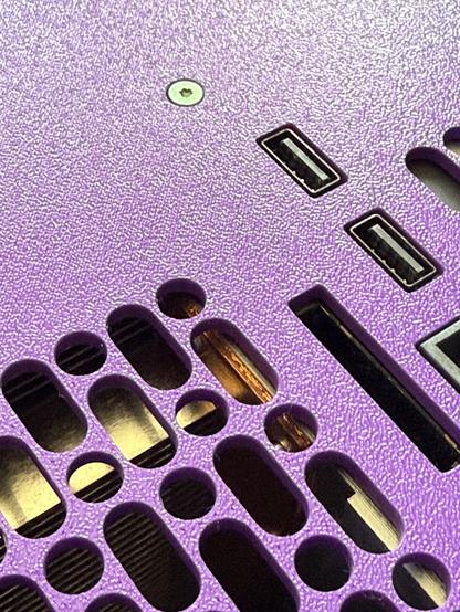 A close up of the ports, grating and recessed screws.