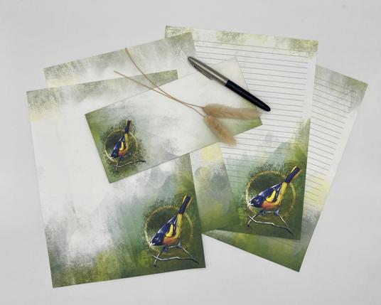 Product photograph of several sheets of art stationery and a matching envelope, featuring the image of an Oriole bird on a textured pastel background.