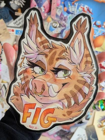 Traditional watercoloured conbadge of an hybrid boar-lynx character