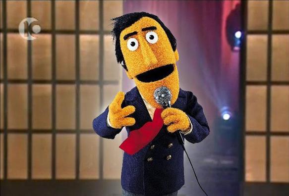 A muppet named Guy Smiley, speaking into a microphone
