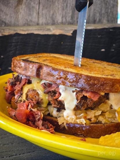 Burger on marble rye, horsey sauce, pastrami, Swiss, and sauerkraut