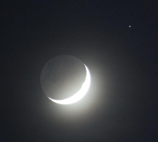 The Moon at waxing crescent phase with nightside illuminated by sunlight reflected by the Earth. The star dot Elnath at upper right side.