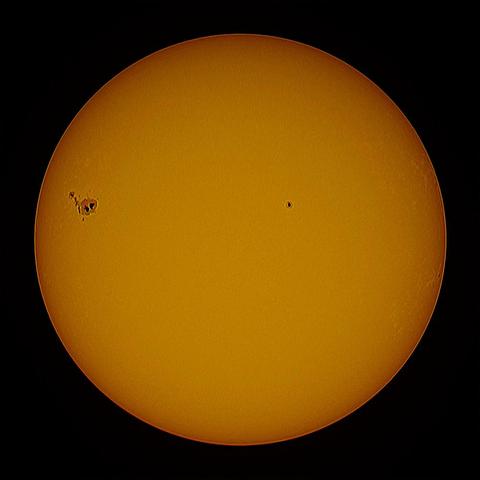 The yellowish Sun with spots on a dark background.