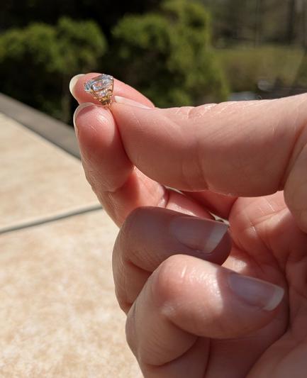 My hand holding an 8mm cubic zirconia earring stud.