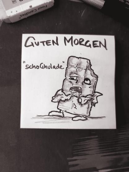 Auf einer Haftnotiz steht "guten Morgen" darunter ist eine untote Tafel Schokolade zu sehen.
Es handelt sich um SchoGhulade