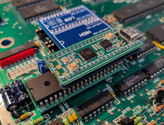 Because the "TOS emulator" board hangs over the DMA chip, I was not sure, if it would still fit after the DMA fix is installed. It does, and this is what's seen on this photo. I managed to install the DMA fix very low, so there's even some small air gap between the top of the DMA chip and the bottom of the ROM board, they don't touch.