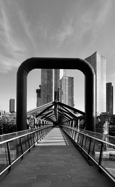 A footpath bridge bringing a sense of symmetry but lost once ‘la folie des grandeurs’ in the background takes over