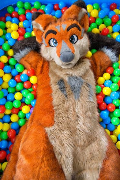 Terrence is lying in a ballpit looking at you