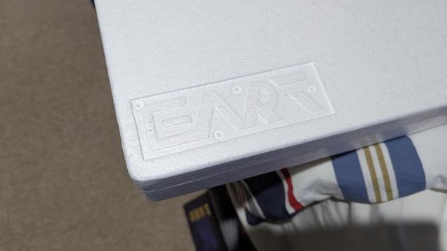 The corner of a Styrofoam box with the word FART, sorry, EART on it.