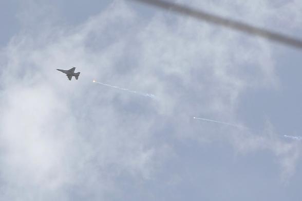An Israeli fighter jet fires a rocket as it flies over an area near the Syrian capital Damascus on April 30, 2025. Syrian state media said Israel conducted strikes on April 30, outside Damascus where deadly sectarian clashes between security forces and local Druze fighters erupted overnight. (Photo by Bakr ALKASEM / AFP)