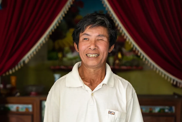 Photo of a man who lost one of his eyes to a bomb - caption ‘Hoan Van Nguyen lost an eye to a cluster bomb that killed his brother and father when they found it in a river, photo by Oliver Marsden for the Sunday Time