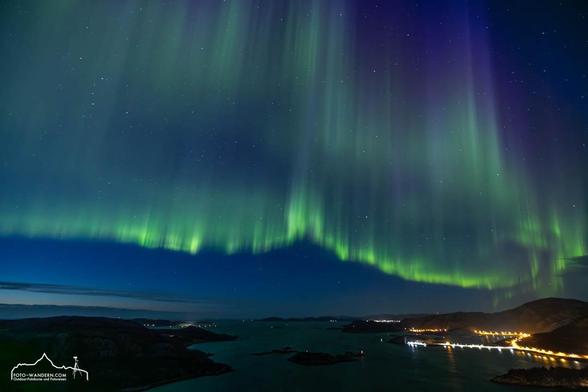 Nordlicht tanzt in grün, blau bis violetten Tönen über  das norwegische Nordmeer