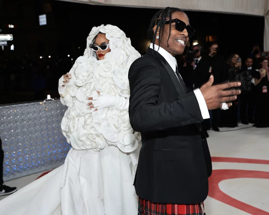 An image of Rihanna and A$AP Rocky (a Black woman and a Black man) posing at the Met Ball 2023. A$AP Rocky is one of the co-chairs of this year's event, which has the theme Superfine: Tailoring Black Style.