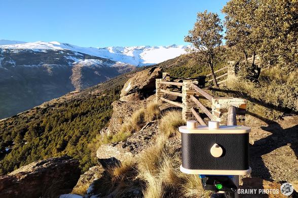 Pinhole camera set-up on a tripod to take a photo of the snow-capped Sierra Nevada mountains