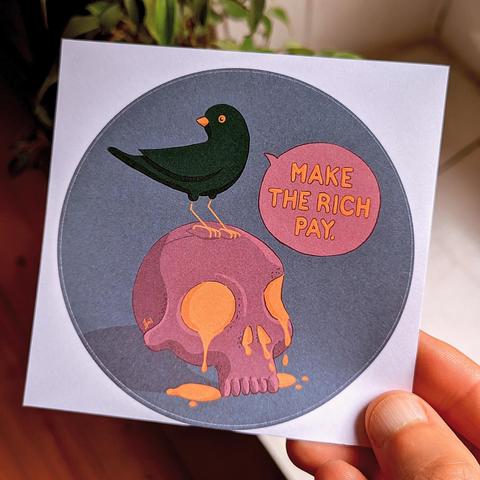Photo of a white dude's hand holding a sticker with an illustration of cute bird sitting on a skull saying „Make the rich pay“. The skull has golden slime (liquid gold?) coming out of it's eye-sockets and nose-holes 🤷‍♀️