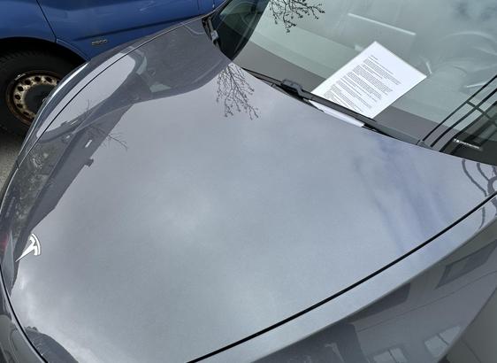 A piece of paper under the window wiper of a tesla