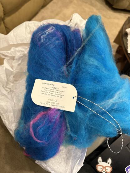 Ponyo’s jellyfish ride - batt with colors ranging from darker blue to light blue/turquoise, splash of pink