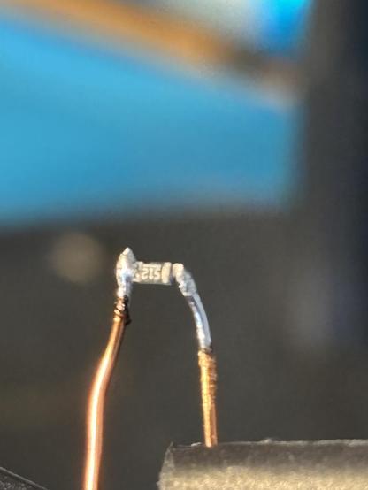 Hand soldered 0603 with two enameled wires coming off. One connection is a bit diffuse and I did fix that up later