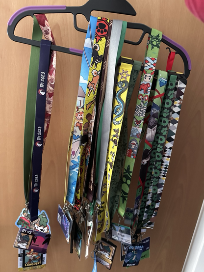 wonky badge holder - a coat hanger with many badges from fur cons
