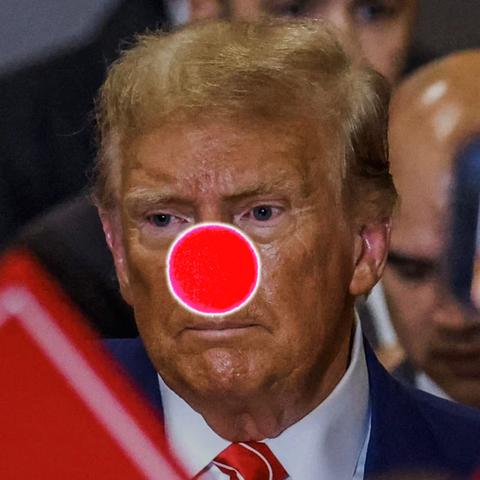 A serious-looking person at what seems like a political rally, standing tall and proud-until you notice the bright red clown nose photoshopped on their face. Because nothing says 'trustworthy politician' like a circus accessory! The blurry crowd behind them is probably wondering if they showed up for a debate or a comedy show, possibly somewhere in Washington D.C., where the real clowns sometimes run the show
