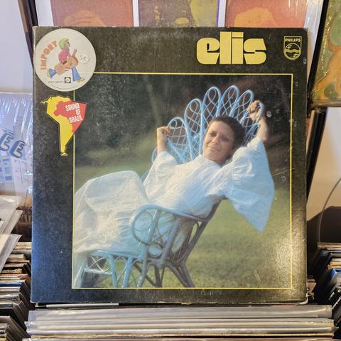 Album cover features a color photograph of ER lounging in a chair in a green grassy yard.  She's wearing a long white dress, and she has very short dark hair.