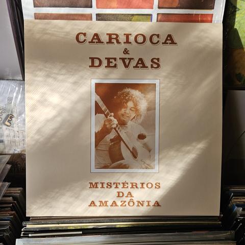 Album cover features photograph of a man playing an acoustic guitar.