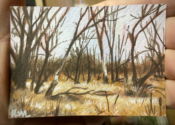 A miniature painting of grassy marsh land dry during winter, with dramatic dormant trees and a glowing patches of grass in the foreground and midground.