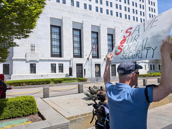 View of the Ohio Supreme Court as we marched by, with a man holding a sign saying,"Aave our Social Security"