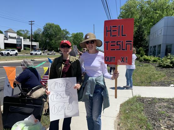 Signs at the Tesla Takedown in Cherry Hill, NJ