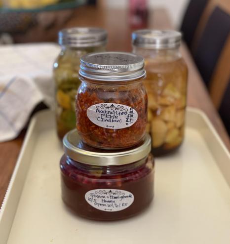 A jar of the described pickle sits on a jar of quince honey. Two vinegar ferments (quince, and citrus peel) are in the background.